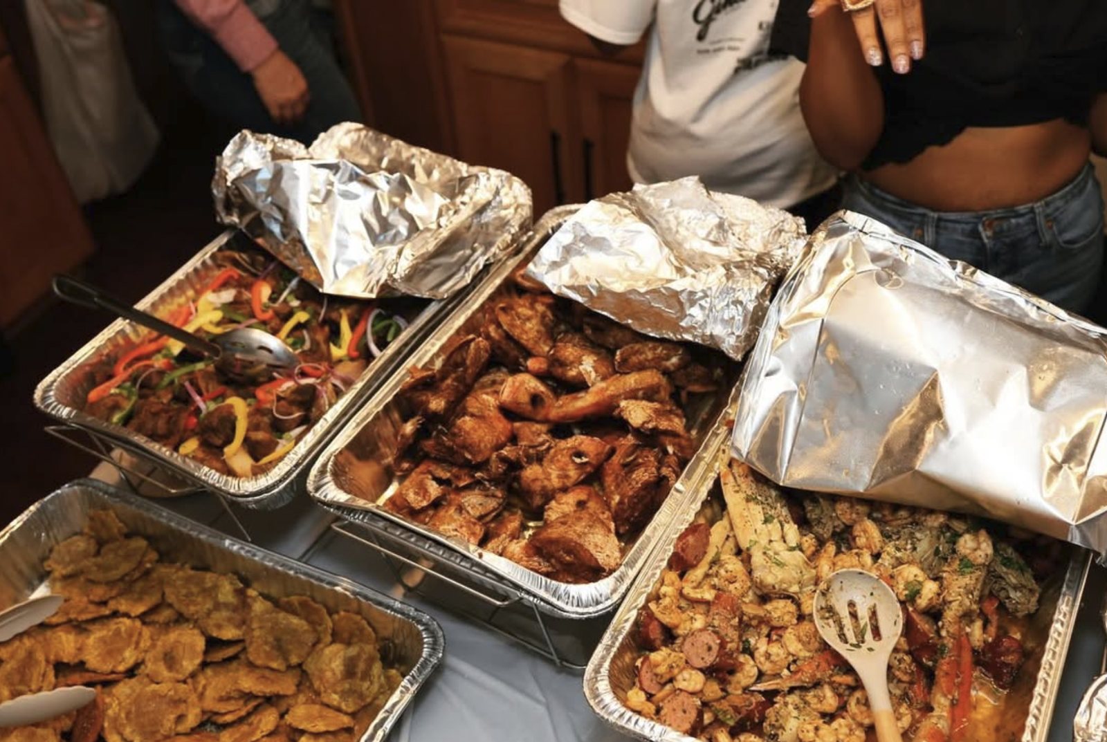 Catering trays filled with grilled food and sides for a Will OTG event